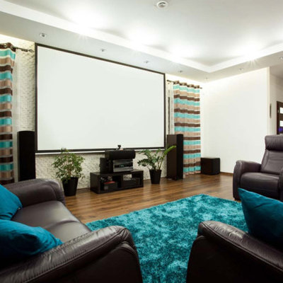 Example of a large trendy enclosed medium tone wood floor and brown floor home theater design in San Francisco with white walls and a projector screen