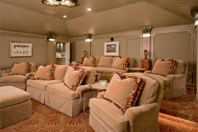 Large traditional enclosed home cinema in Houston with beige walls, carpet and a projector screen.