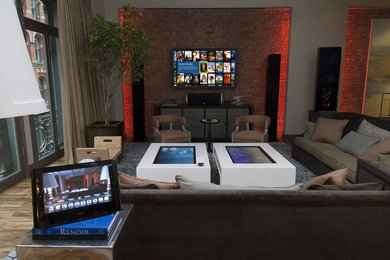 Modelo de cine en casa abierto minimalista de tamaño medio con paredes beige, suelo de madera en tonos medios y televisor colgado en la pared