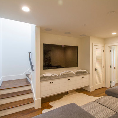 Home theater - mid-sized coastal enclosed dark wood floor home theater idea in Miami with white walls and a wall-mounted tv
