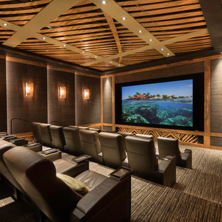 Home theater - tropical enclosed carpeted and gray floor home theater idea in Hawaii with brown walls