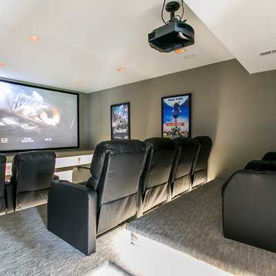 Mid-sized trendy enclosed carpeted and gray floor home theater photo in Seattle with gray walls and a projector screen