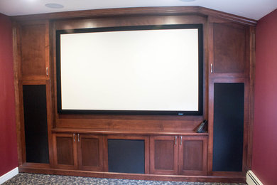 Inspiration for a small timeless enclosed carpeted home theater remodel in New York with red walls and a projector screen