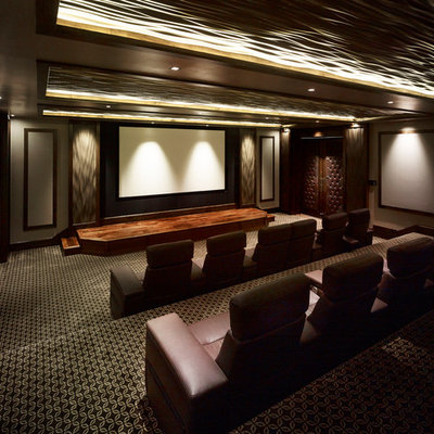Inspiration for a huge timeless enclosed carpeted and multicolored floor home theater remodel in Salt Lake City with brown walls and a projector screen