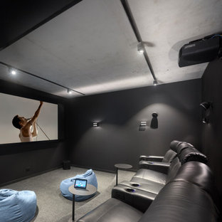 Design ideas for a contemporary enclosed home theatre in Brisbane with black walls, carpet, a projector screen and grey floor.