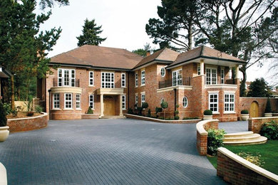 Large and brown modern brick house exterior in Hampshire with three floors.