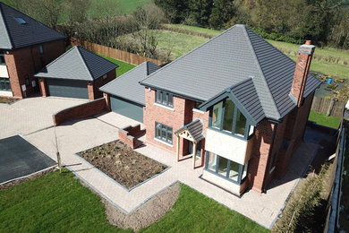 Design ideas for a brown traditional brick detached house in West Midlands with three floors, a pitched roof and a tiled roof.