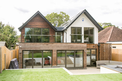 This is an example of a large modern two floor detached house in Dorset with wood cladding.