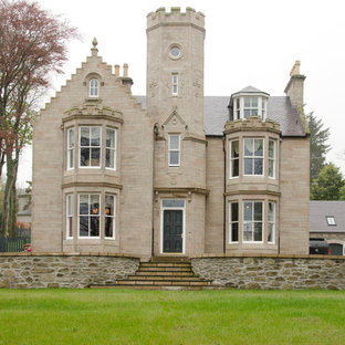 Design ideas for a beige classic two floor detached house in Other with stone cladding and a pitched roof.