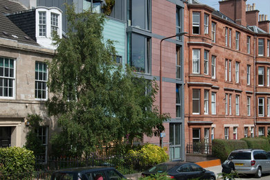 This is an example of a medium sized contemporary flat in Edinburgh with three floors, mixed cladding, a flat roof and a green roof.