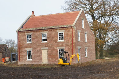 Inspiration for a large farmhouse two floor brick detached house in Other with a pitched roof and a tiled roof.