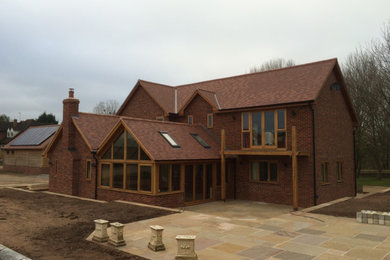 Inspiration for a large and multi-coloured country two floor brick house exterior in West Midlands with a pitched roof.