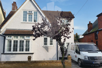 Medium sized and white classic two floor render house exterior in Essex with a pitched roof.