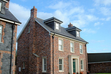 Inspiration for a medium sized traditional brick detached house in Other with three floors, a pitched roof and a tiled roof.