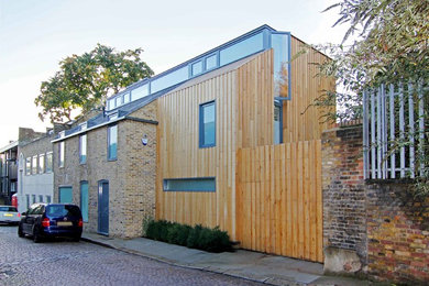 Large contemporary semi-detached house in London with a flat roof and mixed cladding.