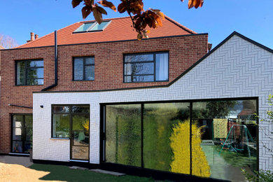 Inspiration for a contemporary detached house in London with mixed cladding.