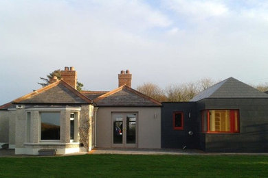 This is an example of a black contemporary bungalow house exterior in Other with concrete fibreboard cladding.