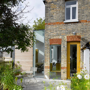 Photo of a medium sized contemporary two floor house exterior in London with mixed cladding.