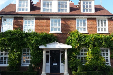 Inspiration for a classic house exterior in Kent with three floors.