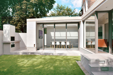 Design ideas for a white contemporary semi-detached house in London with a flat roof.