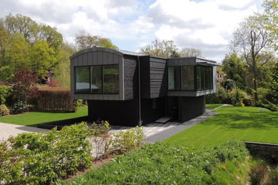 Inspiration for a medium sized and multi-coloured contemporary two floor detached house in Kent with mixed cladding and a metal roof.