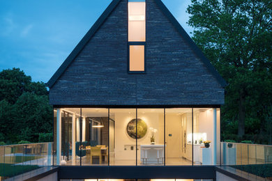 Inspiration for a medium sized contemporary house exterior in Hertfordshire with three floors.