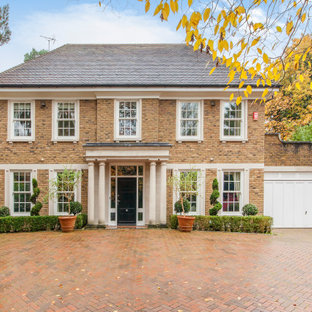 Brown traditional two floor brick detached house in Sussex with a hip roof.