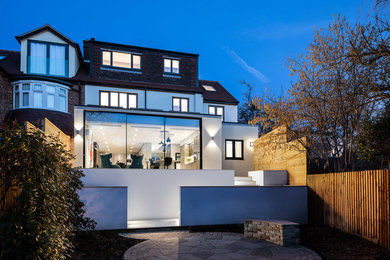 Design ideas for a white contemporary semi-detached house in London with three floors.