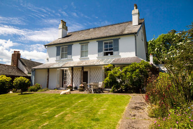Photo of a white traditional two floor house exterior in Devon with a pitched roof.
