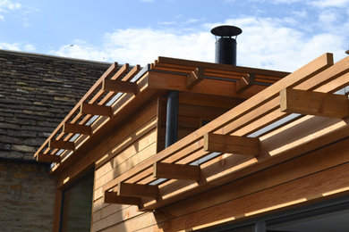 Inspiration for a contemporary house exterior in Other with wood cladding.