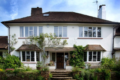 Design ideas for a white rustic two floor house exterior in Surrey.