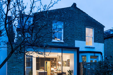 Diseño de fachada de casa bifamiliar multicolor contemporánea de tamaño medio de una planta con revestimiento de ladrillo, tejado plano y tejado de varios materiales