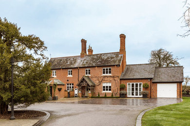 Inspiration for a large traditional brick detached house in Essex with three floors, an orange house and a tiled roof.