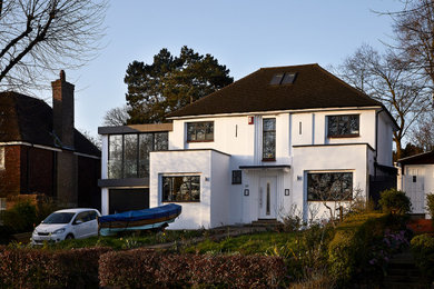 Design ideas for a large and white modern two floor render detached house in London with a flat roof.