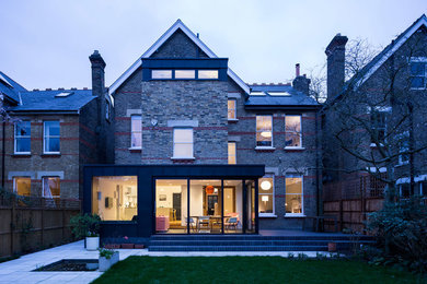 Large modern detached house in London with three floors and metal cladding.