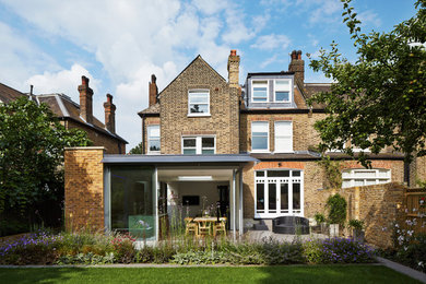 This is an example of a traditional brick and rear extension in London with three floors and a pitched roof.