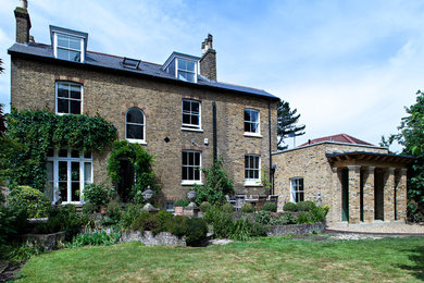 This is an example of a large victorian brick house exterior in London with three floors.