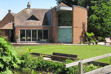 Photo of a large contemporary brick house exterior in Berkshire.