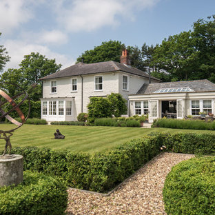 Inspiration for a white and large traditional two floor brick detached house in Other with a hip roof and a shingle roof.