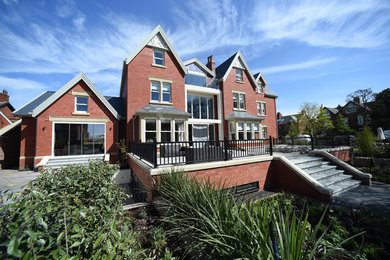 Inspiration for a large classic brick detached house in Other with three floors, a pitched roof and a tiled roof.