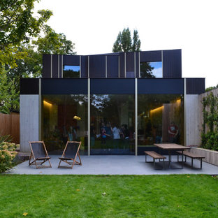 This is an example of a large and multi-coloured modern detached house in London with mixed cladding.