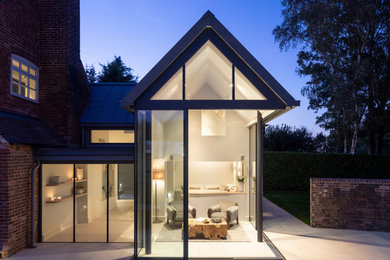 Inspiration for a large contemporary detached house in West Midlands with three floors, metal cladding, a pitched roof and a metal roof.