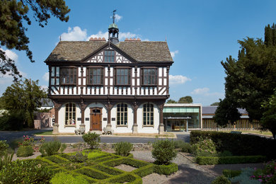 Photo of a large and white traditional detached house in West Midlands with three floors and wood cladding.
