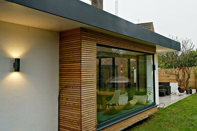 Medium sized contemporary bungalow house exterior in West Midlands with mixed cladding.