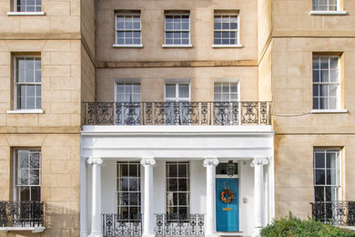 Medium sized and white classic terraced house in London with three floors.