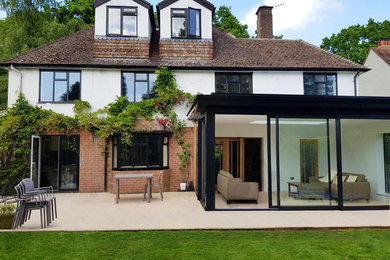 Photo of a large contemporary house exterior in Hertfordshire with three floors.