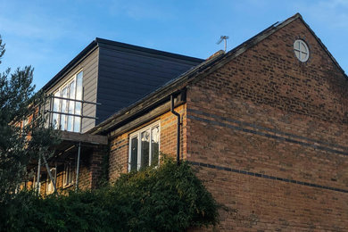 Example of a mid-sized trendy three-story townhouse exterior design in London