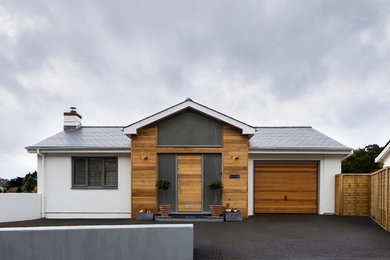 Inspiration for a white contemporary bungalow detached house in Devon with mixed cladding and a pitched roof.