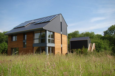 Photo of a modern house exterior in Buckinghamshire with wood cladding and three floors.