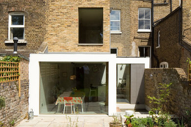 Inspiration for a medium sized and beige contemporary brick terraced house in London with three floors.